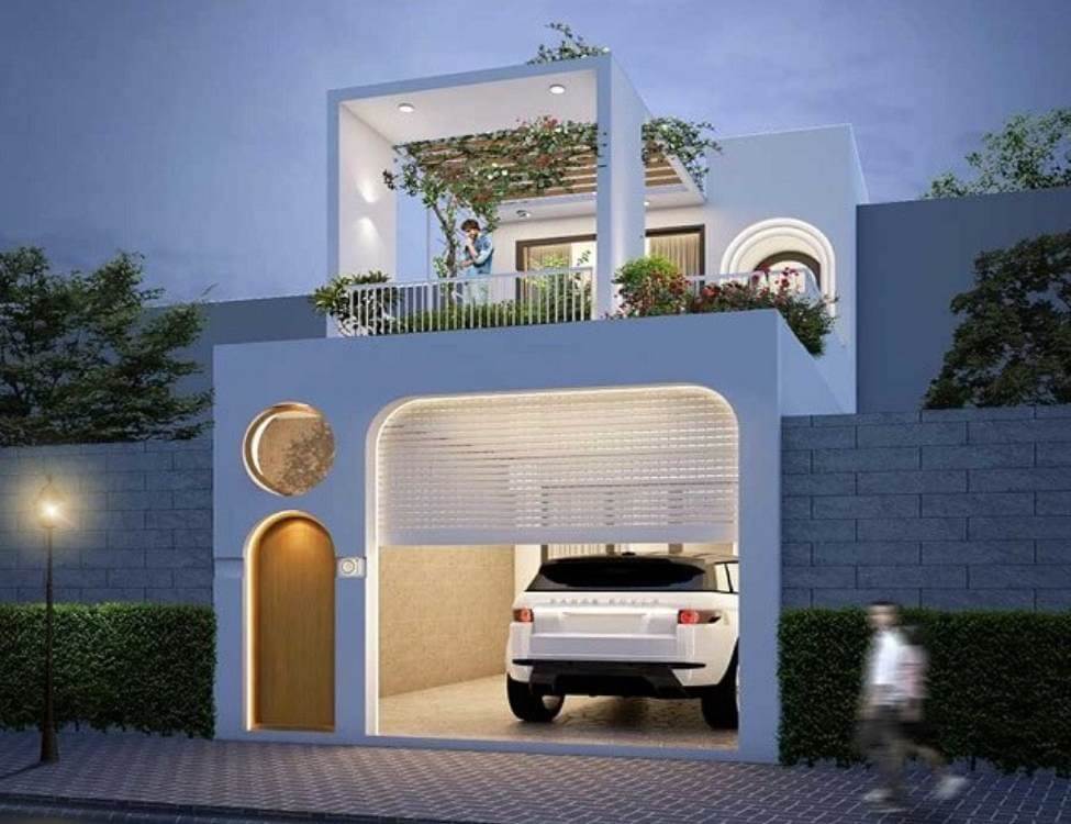 Nhà hiện đại hai tầng có gara ô tô và ban công phủ cây xanh vào buổi tối.