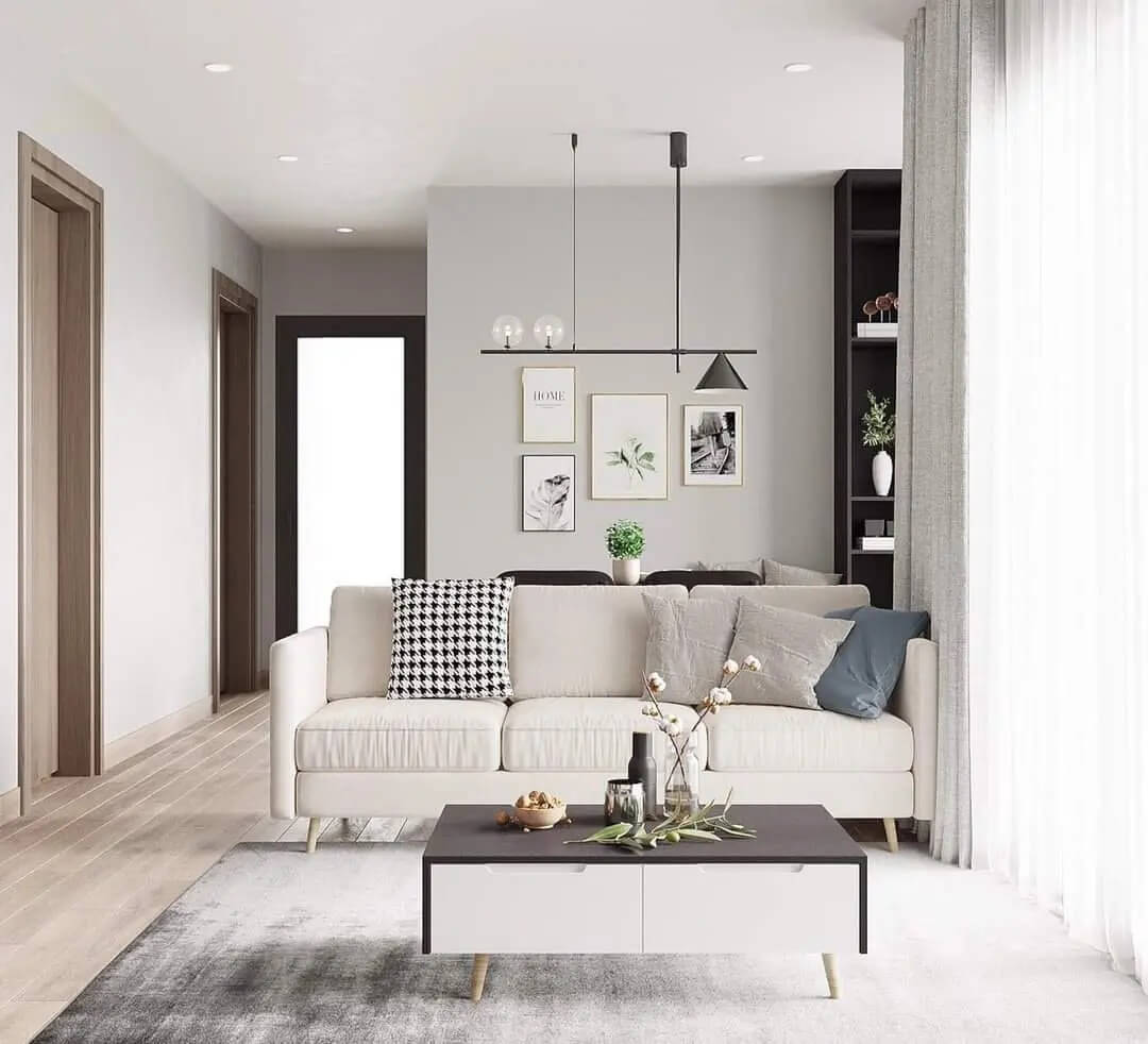 Phòng khách hiện đại với ghế sofa trắng, bàn cafe nhỏ và trang trí tường phong cách tối giản.