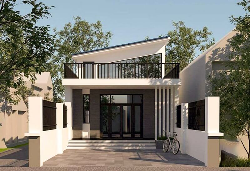 Nhà phố hiện đại hai tầng với sân và bụi cây xanh, thiết kế tối giản và thoáng đãng.