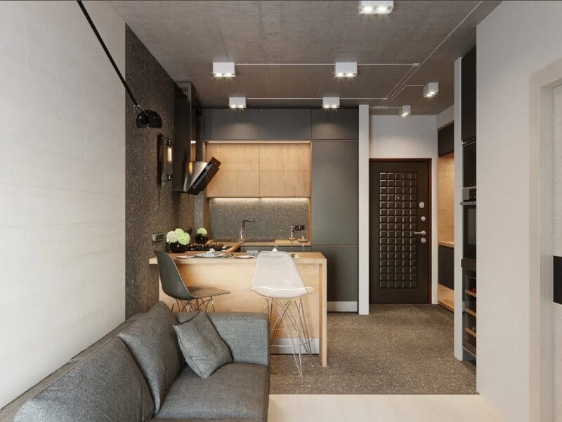 Phòng bếp hiện đại với nội thất gỗ, bàn ăn và ghế sofa thoải mái, ánh sáng thiết kế tinh tế.