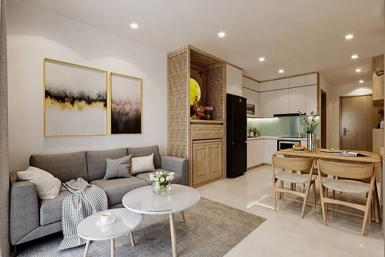 Phòng khách căn hộ hiện đại với sofa xám, bàn trà tròn và bếp mở, thiết kế nội thất tinh tế và ấm cúng.