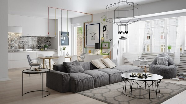 Phòng khách và bếp tối giản với sofa xám, bàn tròn và cửa sổ lớn, ánh sáng tự nhiên ấm áp.