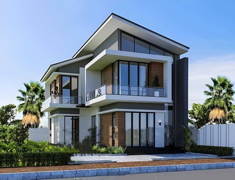 Biệt thự hai tầng hiện đại với cửa kính lớn, mái dốc, cây cối xung quanh tạo không gian thoáng đãng và tiện nghi.