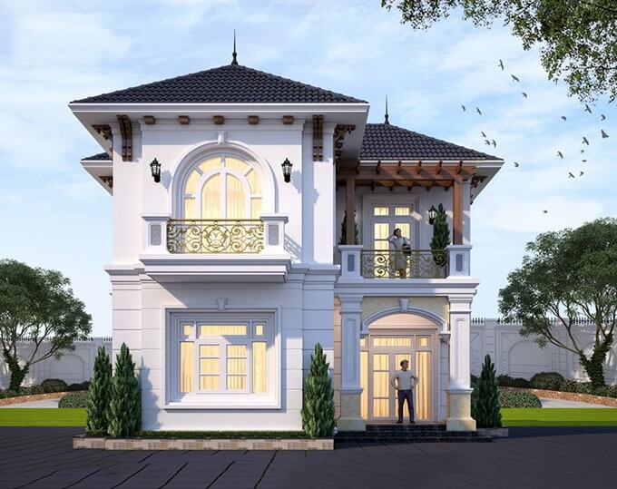 Biệt thự 2 tầng màu trắng với cửa sổ lớn, ban công đẹp, mái ngói đen và cây xanh xung quanh, thiết kế sang trọng.