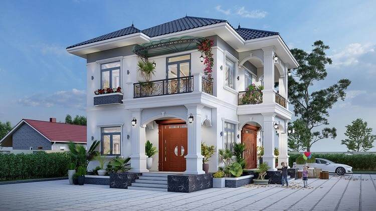 Nhà biệt thự hai tầng hiện đại với mái ngói xanh, sân rộng và cây cảnh, bên cạnh là ô tô và cây xanh.