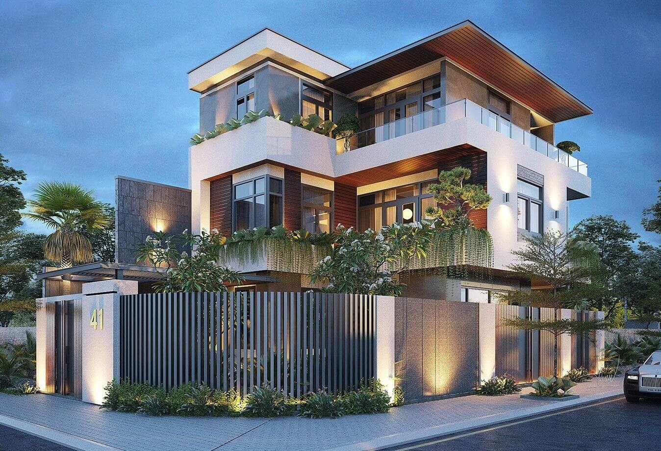 Biệt thự hiện đại với kiến trúc ba tầng, ánh sáng ấm áp về đêm, cây xanh xung quanh và hàng rào số 41 trước nhà.