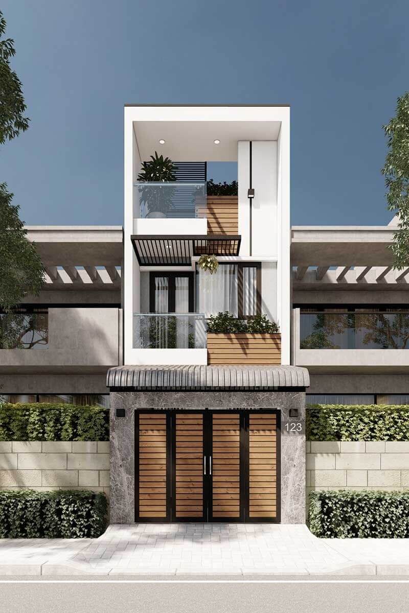 Nhà phố hiện đại 3 tầng với thiết kế tối giản, ban công kính và ốp gỗ, bao quanh bởi cây xanh.