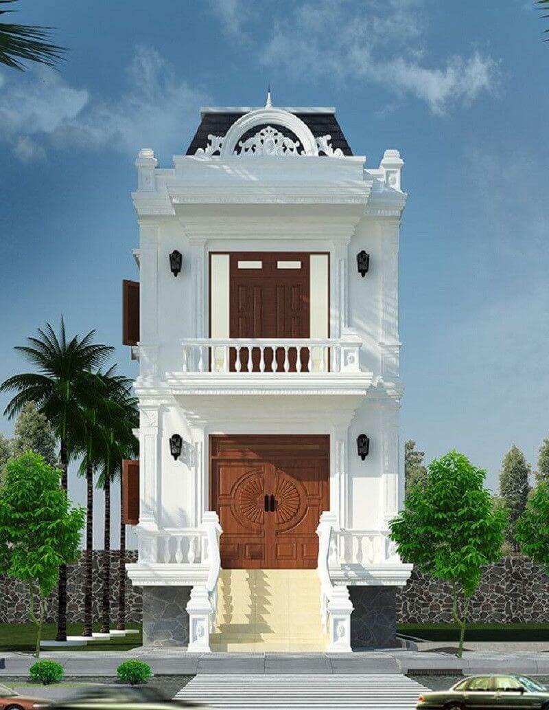 Nhà hai tầng phong cách tân cổ điển, mặt tiền trắng, cửa gỗ lớn, cây xanh xung quanh.