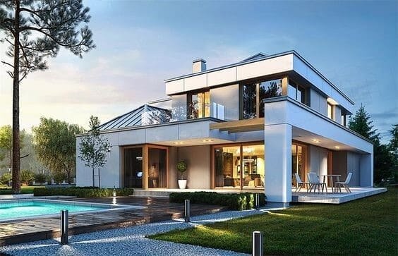 Biệt thự hiện đại bên hồ bơi với thiết kế kính và không gian mở, bao quanh bởi cây cối xanh tươi.