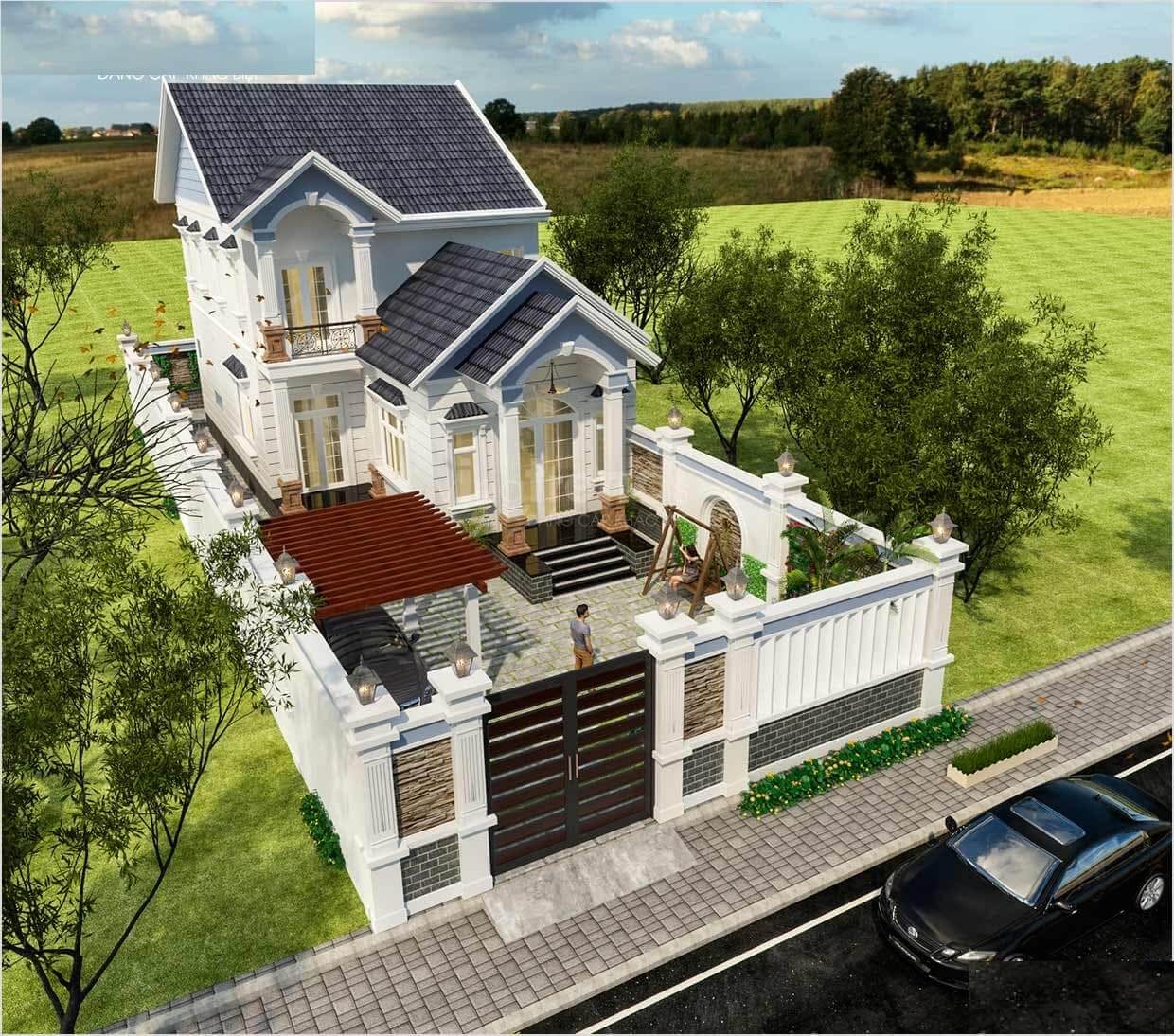 Nhà hai tầng hiện đại với sân vườn và cổng lớn, nằm giữa cánh đồng xanh mát.