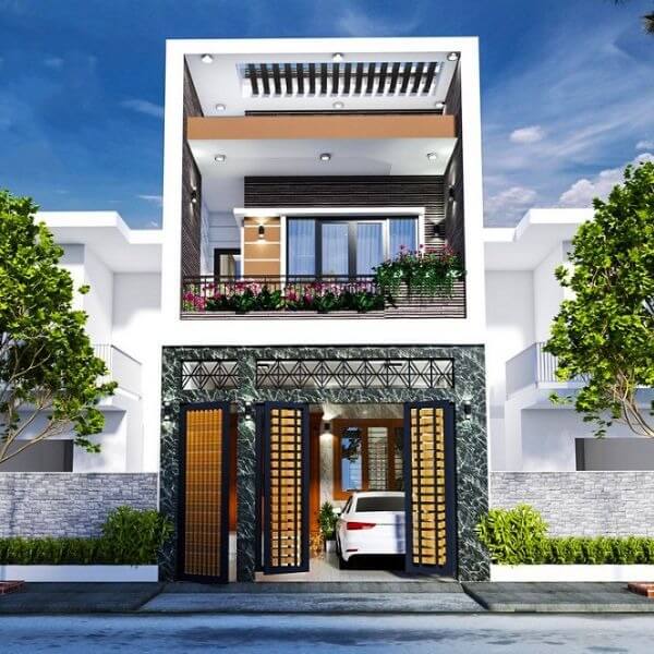 Nhà phố hiện đại, 3 tầng với ban công rộng rãi và cửa kính lớn, cây xanh phía trước và ô tô đậu trong gara.