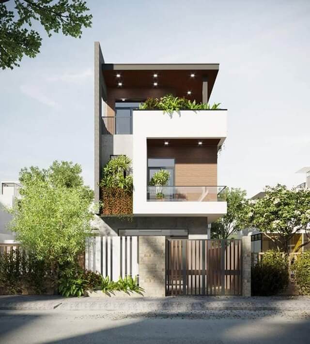 Nhà hiện đại 3 tầng với ban công cây xanh, thiết kế tối giản và cổng sang trọng.