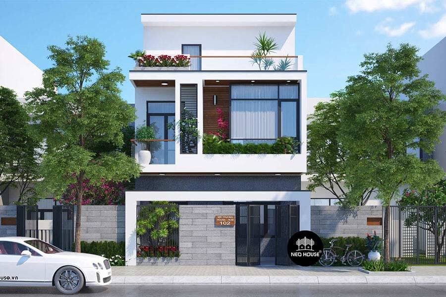 Ngôi nhà hiện đại hai tầng với cây xanh xung quanh và ô tô đỗ phía trước.