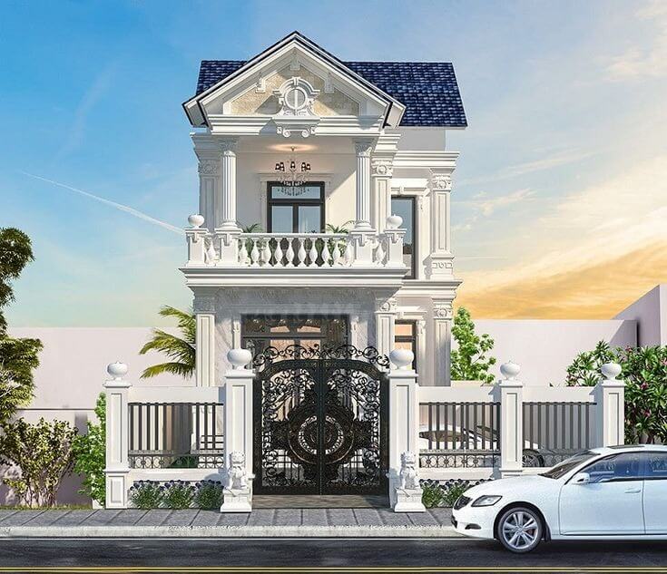 Nhà phố 2 tầng sang trọng với hàng rào trắng và cổng sắt, xe hơi đậu trước, ánh hoàng hôn nền trời.