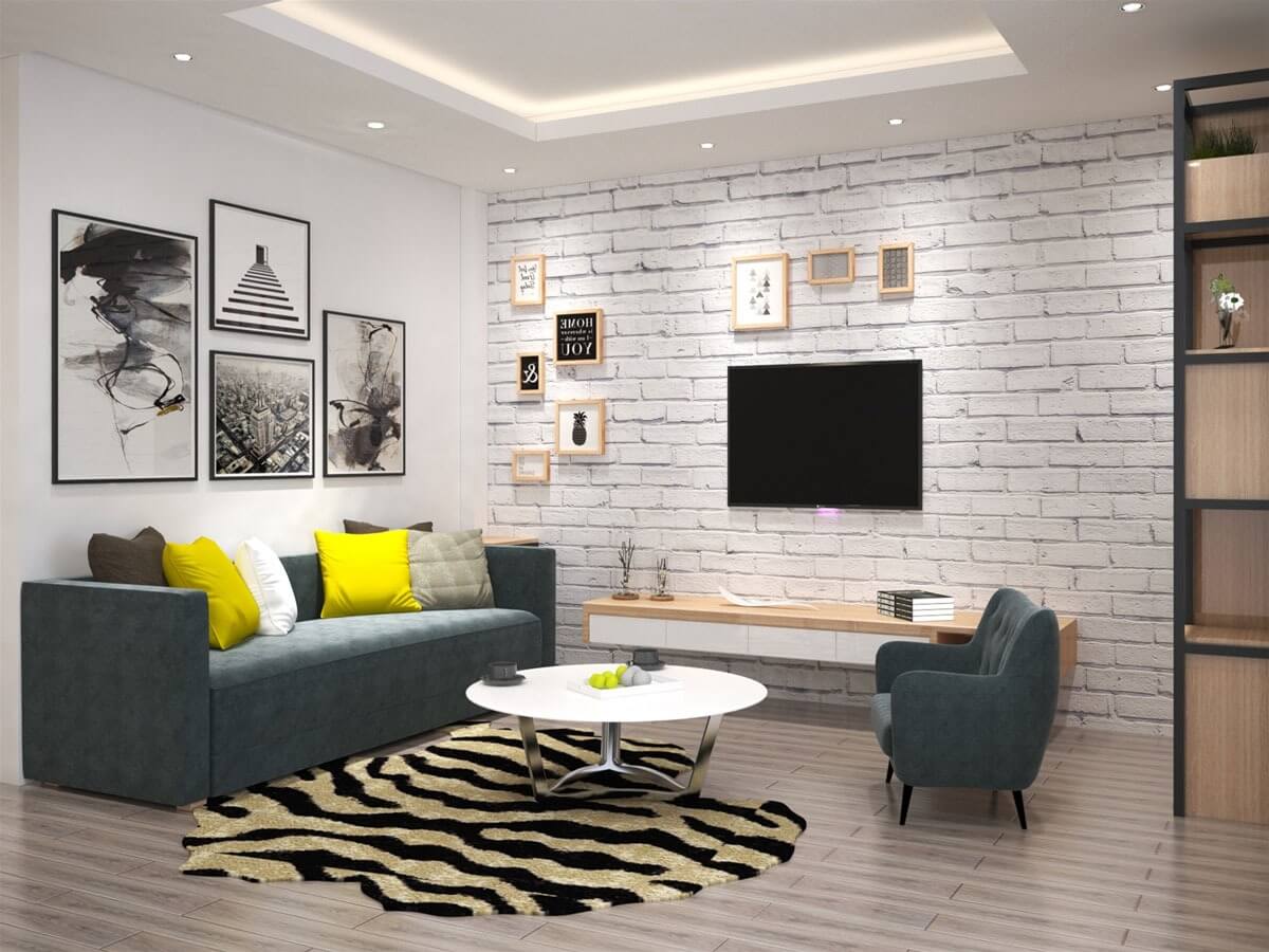 Những bức tranh treo tường và những chiếc gối màu sắc trên ghế sofa chính là điểm nhấn của phòng khách