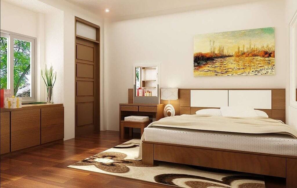 Phòng ngủ hiện đại với giường gỗ, tranh treo tường, ánh sáng tự nhiên từ cửa sổ và nội thất sang trọng.