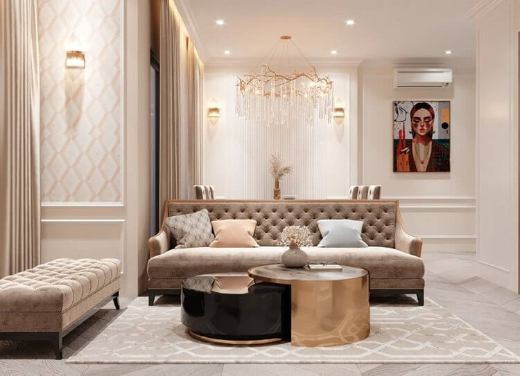 Phòng khách sang trọng với sofa nâu, bàn tròn đôi và đèn chùm, tạo không gian ấm cúng và hiện đại.