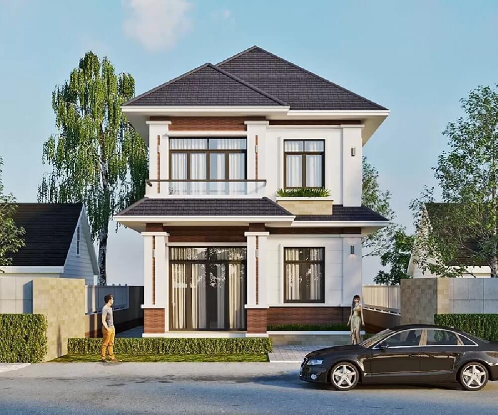 Nhà hai tầng thiết kế hiện đại với mái ngói, cây xanh và ô tô đỗ phía trước, xuất hiện trong môi trường đô thị.