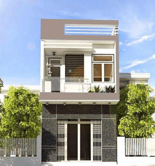 Ngôi nhà 2 tầng hiện đại màu trắng có ban công và cửa sổ lớn, bao quanh bởi cây xanh, dưới bầu trời trong xanh.