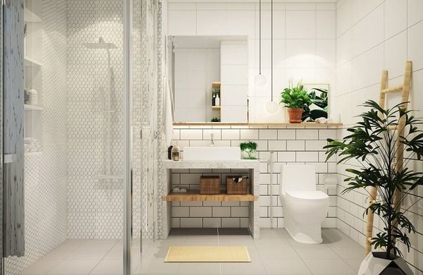 Phòng tắm hiện đại với gạch trắng, bồn rửa, bồn cầu và cây xanh trang trí.