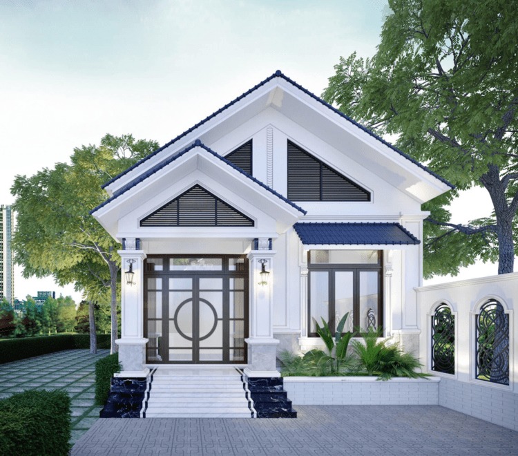 Nhà mái thái màu trắng với cửa gỗ lớn và cảnh quan cây xanh xung quanh.