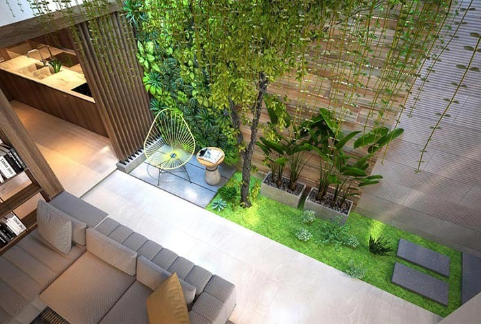 Không gian phòng khách hiện đại với cây xanh trang trí, sofa góc và ghế độc đáo, tạo cảm giác thư giãn.