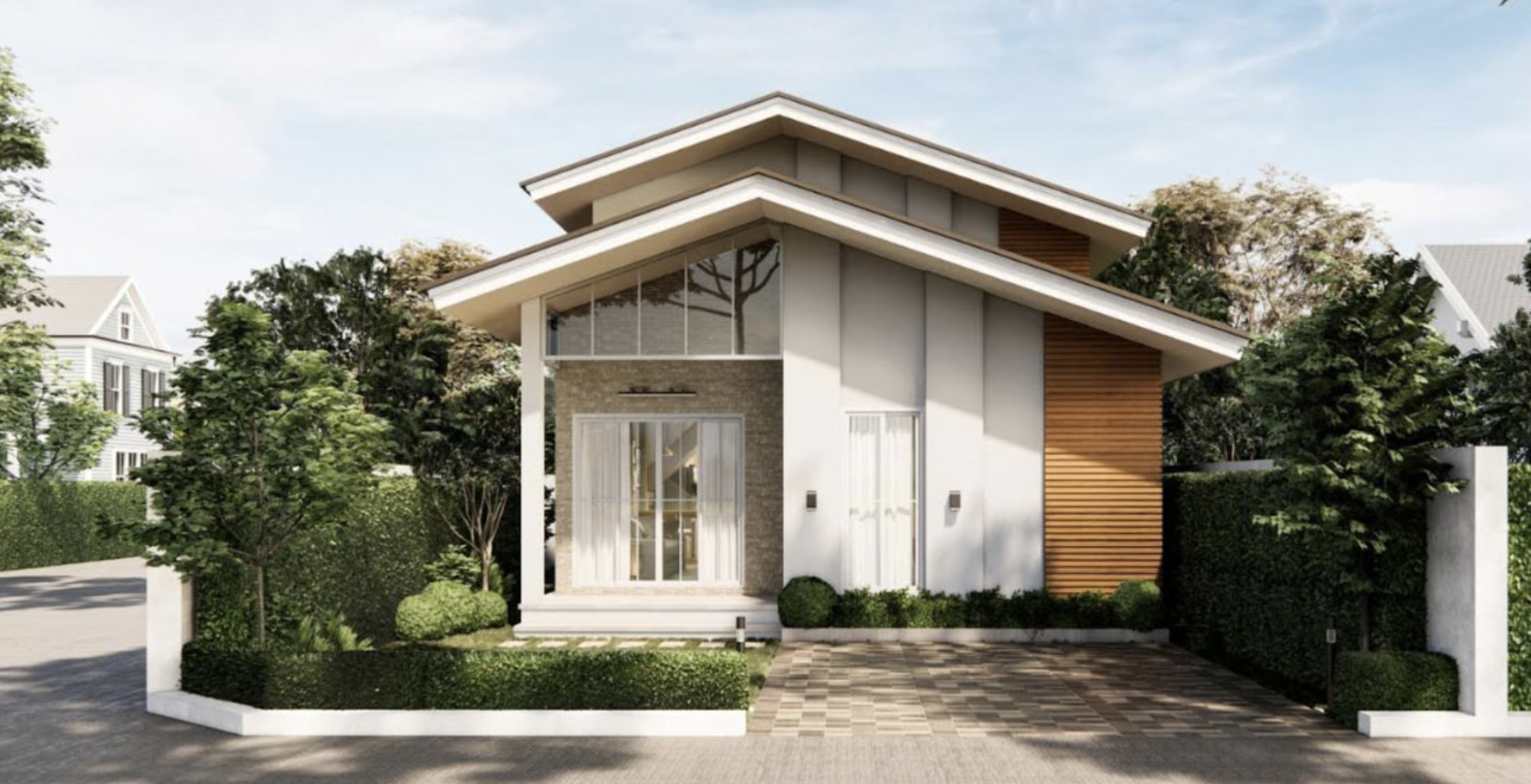 Nhà hiện đại một tầng với mái chéo và sân nhỏ, bao quanh bởi cây xanh.