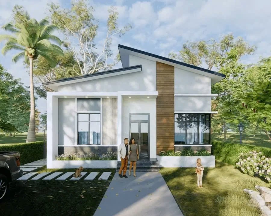 Ngôi nhà hiện đại có mái xéo, vườn xanh và gia đình đứng trước cửa, tạo cảm giác ấm cúng và thanh bình.