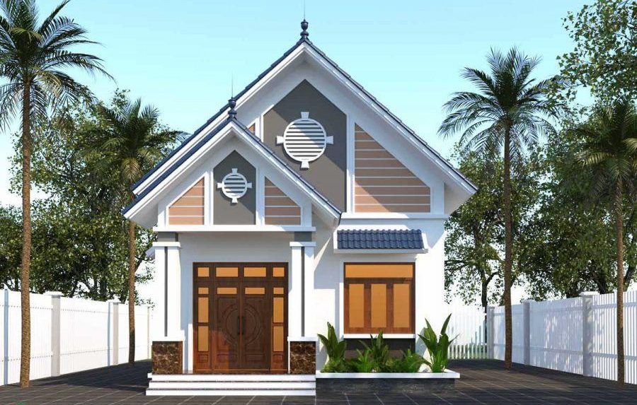 Ngôi nhà mái thái hiện đại với tường sơn trắng, cửa gỗ, mái xanh, bao quanh bởi hàng rào trắng và cây xanh.