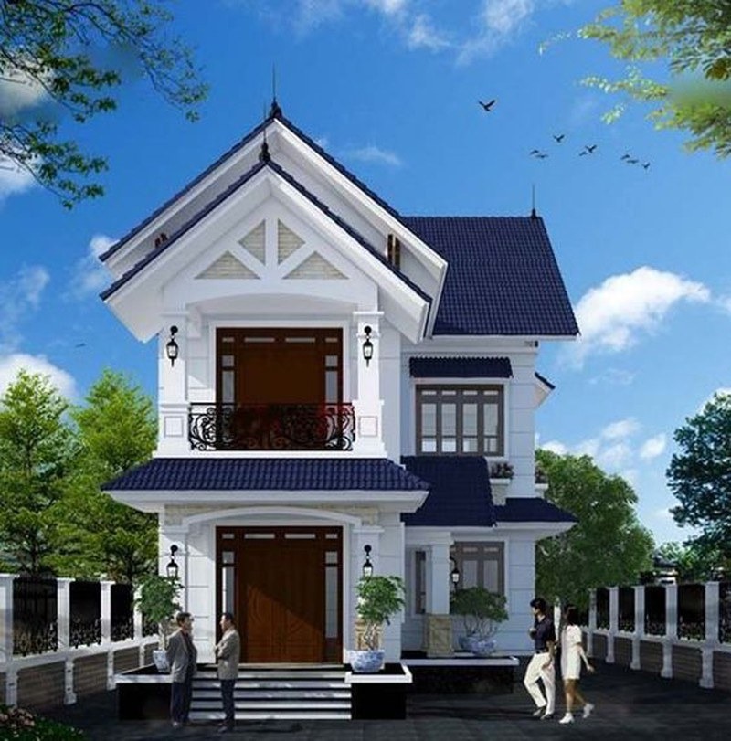 Nhà biệt thự 2 tầng với mái ngói xanh, kiến trúc hiện đại, xung quanh là cây cối xanh mát.