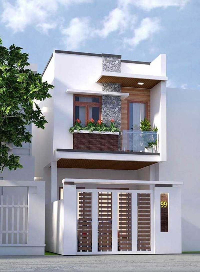 Nhà phố hiện đại hai tầng với thiết kế ban công và cây xanh, mặt tiền màu trắng nổi bật.