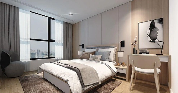 Phòng ngủ hiện đại với cửa sổ lớn, giường êm ái, bàn làm việc và tranh treo tường tinh tế.