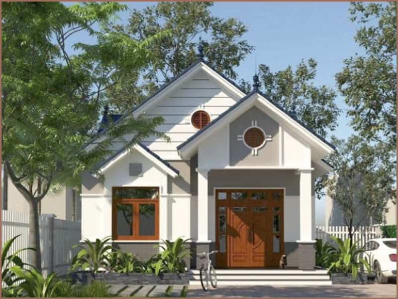 Nhà cấp 4 mái thái giữa vườn xanh, cửa gỗ, tường trắng, xe đạp phía trước.