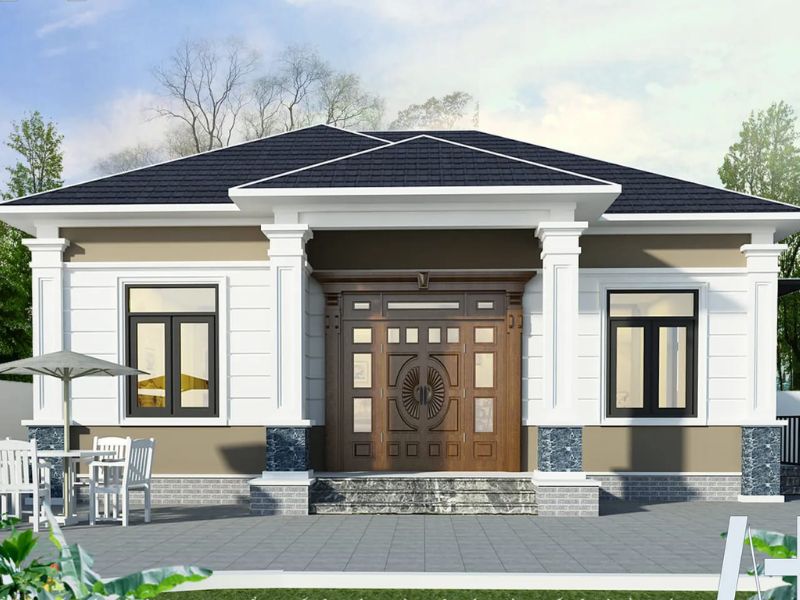 Ngôi nhà cấp 4 phong cách hiện đại với mái thái xám, cửa gỗ tinh tế, bàn ghế ngoài trời và khoảng sân rộng thoáng đãng.