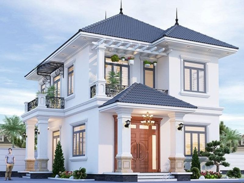 Biệt thự hai tầng hiện đại với mái ngói xanh và ban công trang trí cây xanh.