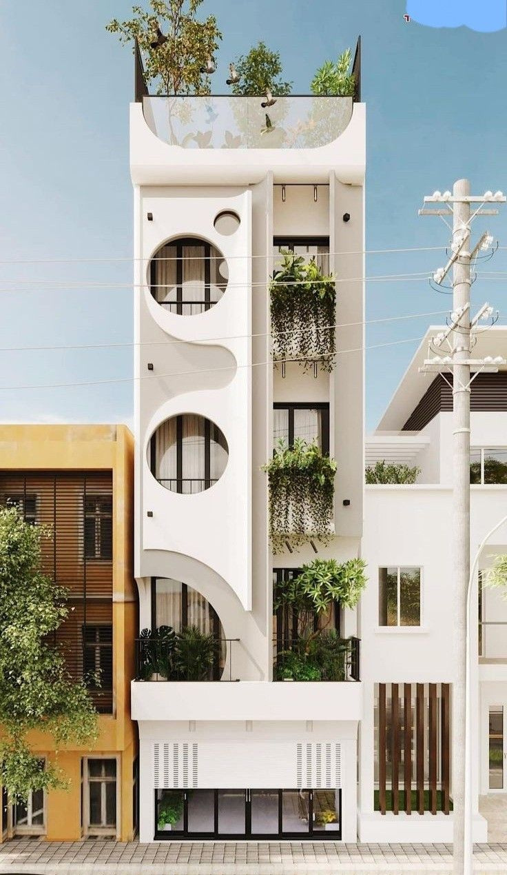 Tòa nhà hiện đại với thiết kế sáng tạo, ban công có cây xanh, tạo cảm giác gần gũi thiên nhiên.