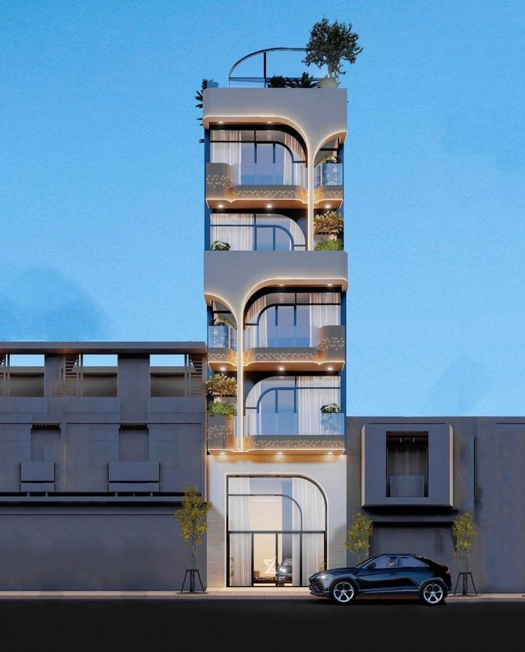 Tòa nhà hiện đại cao tầng với mặt tiền kính, ánh sáng về đêm, phong cách thiết kế độc đáo, xe hơi phía trước.