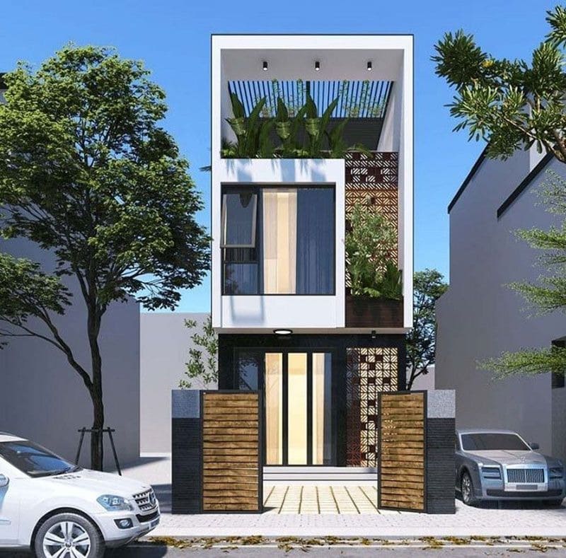 Nhà phố hiện đại 3 tầng với cây xanh ở ban công, ô tô đỗ trước nhà, thiết kế sáng tạo và tối giản.