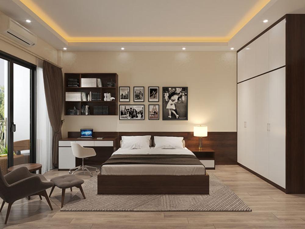 Phòng ngủ hiện đại với nội thất gỗ, giường đôi, bàn làm việc và ghế tựa thoải mái, trang trí tranh ảnh trên tường.