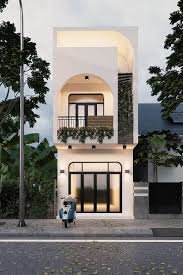 Nhà ba tầng hiện đại với ban công và cây xanh, xe máy đỗ phía trước, nền trời xanh biếc.