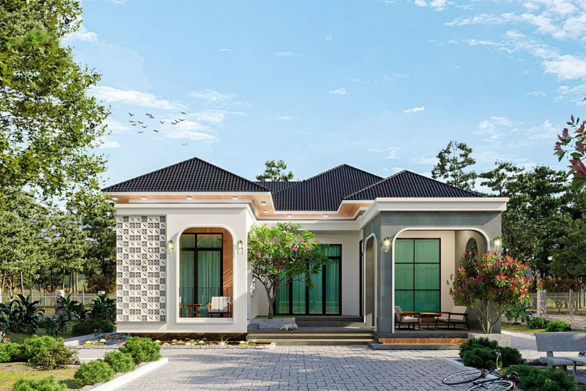 Ngôi nhà mái ngói hiện đại với khu vườn xanh mát, ghế thư giãn dưới bầu trời trong xanh.