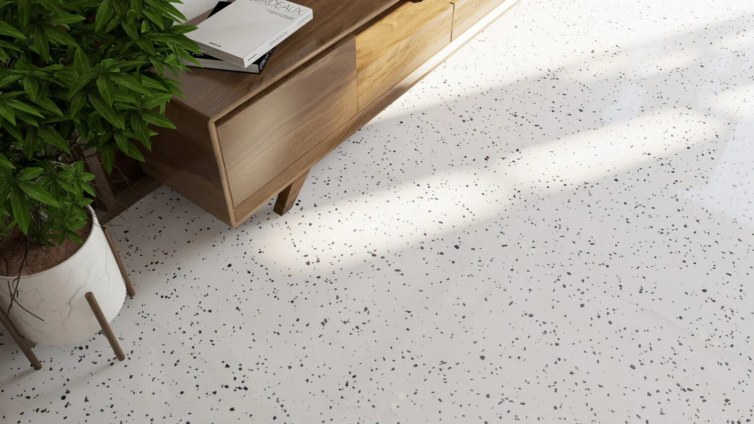 1a68cgb9yneid3fo0vkl Nội thất phòng khách với sàn terrazzo trắng, kệ gỗ và cây cảnh xanh, ánh sáng tự nhiên chiếu qua cửa sổ.