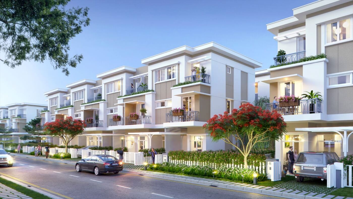 Dãy nhà liền kề hiện đại với ban công rộng rãi và cây xanh trang trí. Xe ô tô đậu phía trước, cảnh quan yên bình.