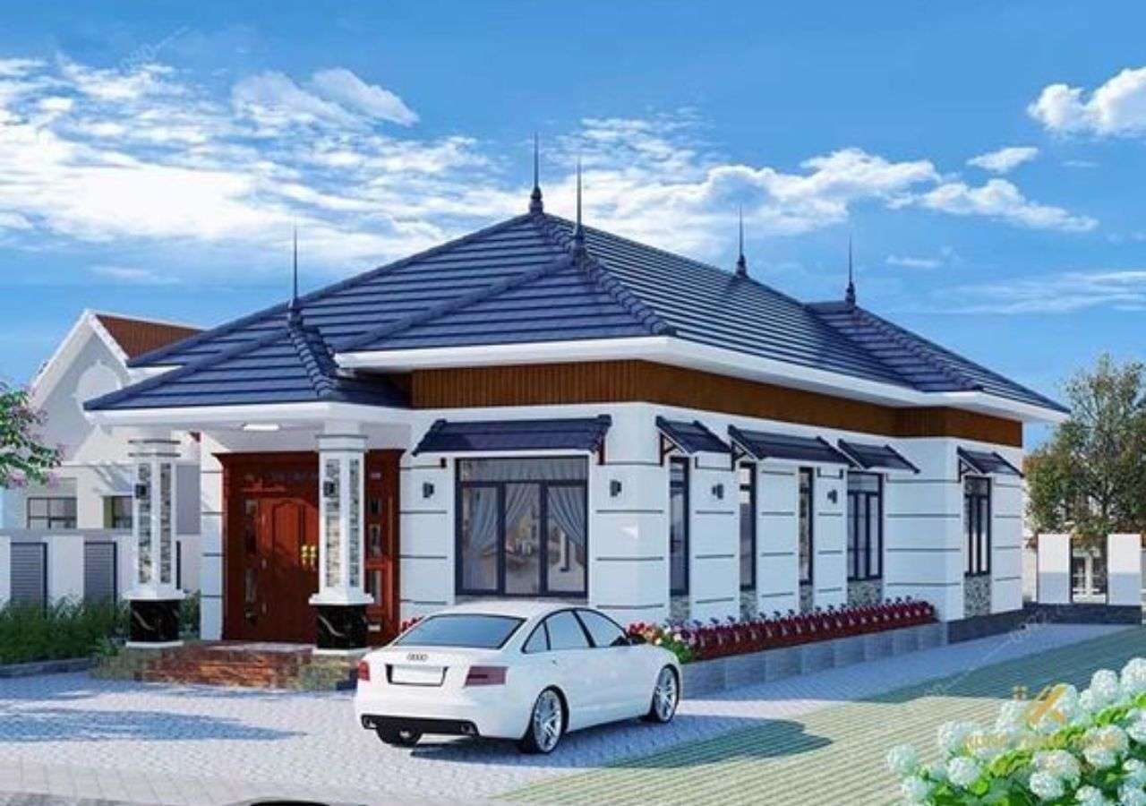 Ngôi nhà mái ngói xanh, thiết kế hiện đại, xe hơi đậu trước cửa dưới bầu trời xanh.