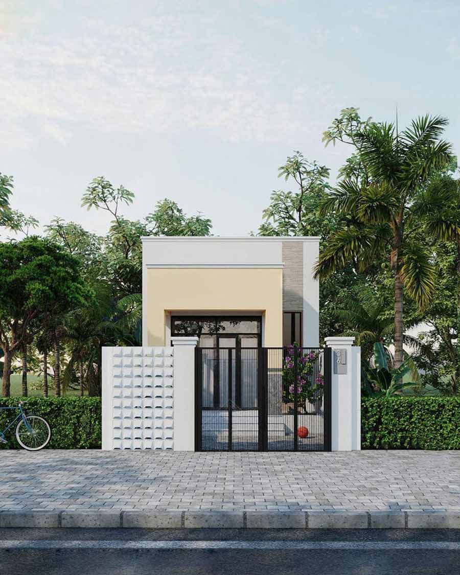 Nhà phố hiện đại giữa khung cảnh thiên nhiên, thiết kế giản dị kết hợp hàng rào sắt và cây cối xanh tươi xung quanh.