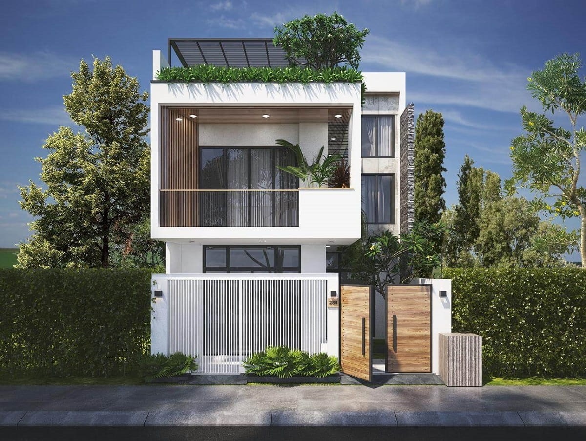 Ngôi nhà hai tầng hiện đại với mái che và cây xanh tươi tốt, nằm trong khu vực nhiều cây lớn xung quanh.