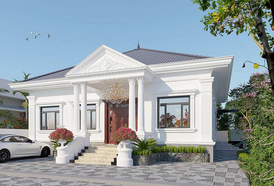 Biệt thự hiện đại với mái ngói xanh, cột trắng, sân vườn và xe hơi đỗ phía trước.