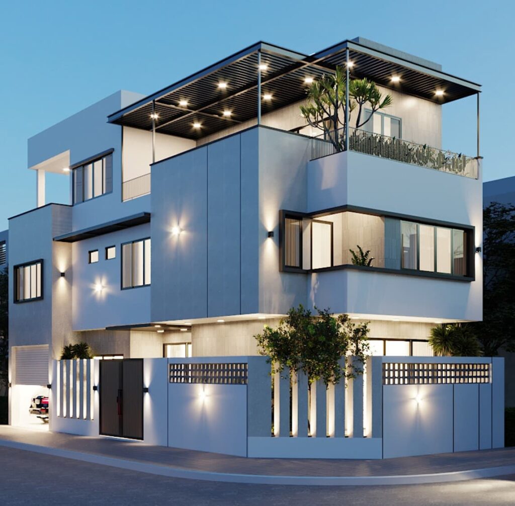 Nhà phố hiện đại 3 tầng với kiến trúc tối giản, ban công rộng, cây xanh và ánh sáng buổi tối nổi bật.