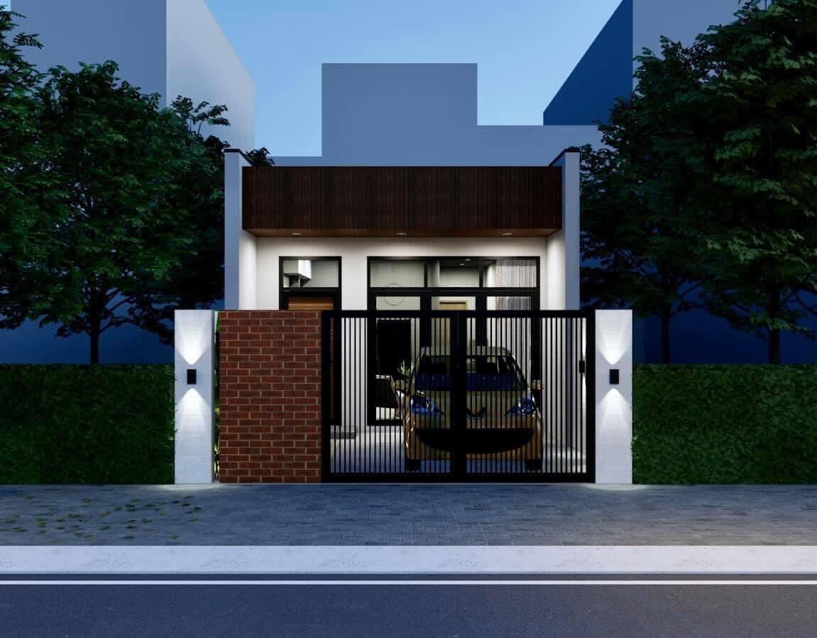 Ngôi nhà phố hiện đại với cổng gỗ và gạch, xe hơi đậu trong sân, ánh sáng tối giản về đêm.
