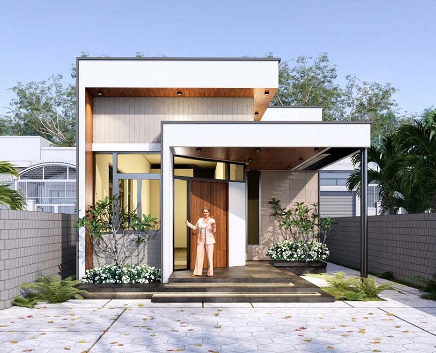 Người phụ nữ đứng trước một căn nhà hiện đại với sân rộng và cây xanh tạo nên cảnh quan mát mẻ.